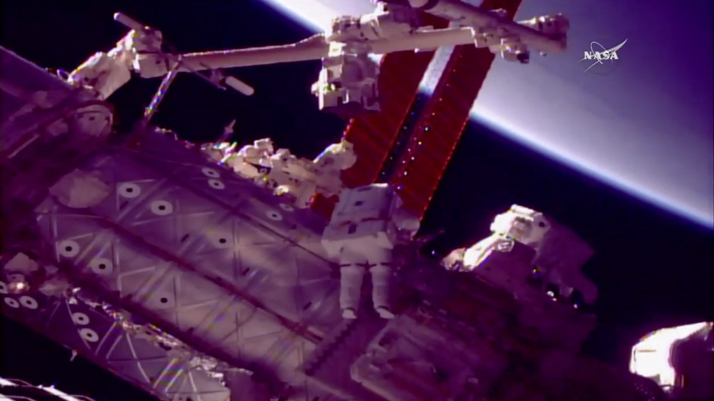 Spacewalking astronauts give new hand to robot arm